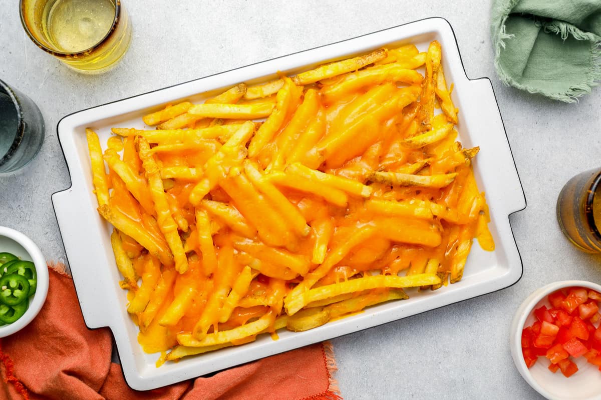 French fries with melted cheese on top. - 12