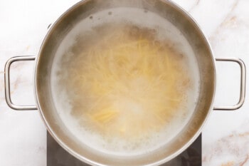 fettuccini cooking in a pasta pot.