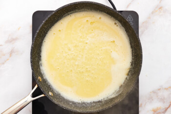 cheese added to butter and water mixture in a skillet.