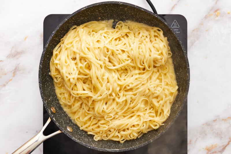 fettuccini alfredo in a skillet.