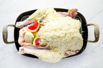 a roasted chicken in a cast iron pan.