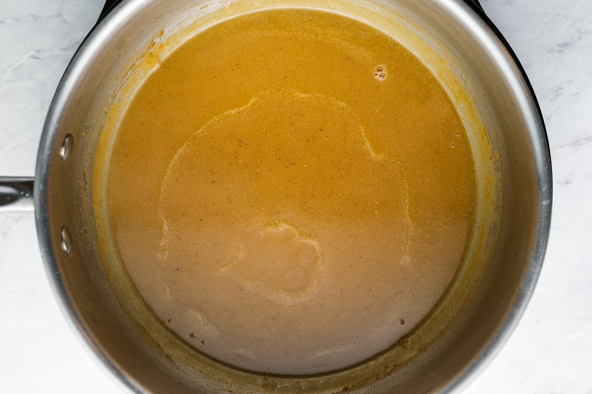 a pot full of soup in a stainless steel pot.