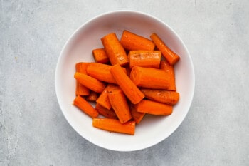 crockpot glazed carrots in a white bowl.