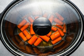 crockpot glazed carrots cooking in a covered crockpot.
