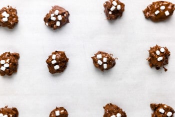 flourless hot chocolate cookie dough balls spread out on parchment paper.