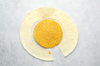 a large flour tortilla cut to match the size of a small corn tostada.