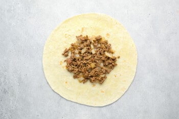 ground beef on a large flour tortilla.