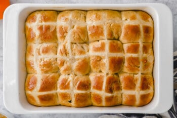 baked hot cross buns in a rectangular baking dish.