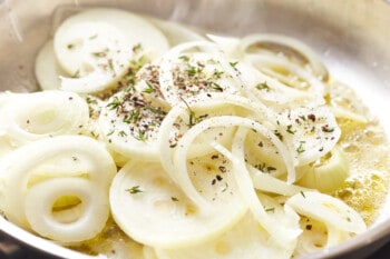 sliced onions and seasonings in a pan.