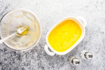 overhead view of raw scrambled eggs in a small rectangular pan.