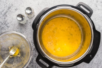 overhead view of raw scrambled eggs in an instant pot.