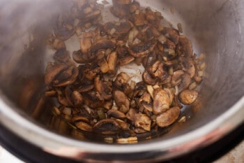 mushrooms and onions sauteeing in an instant pot.