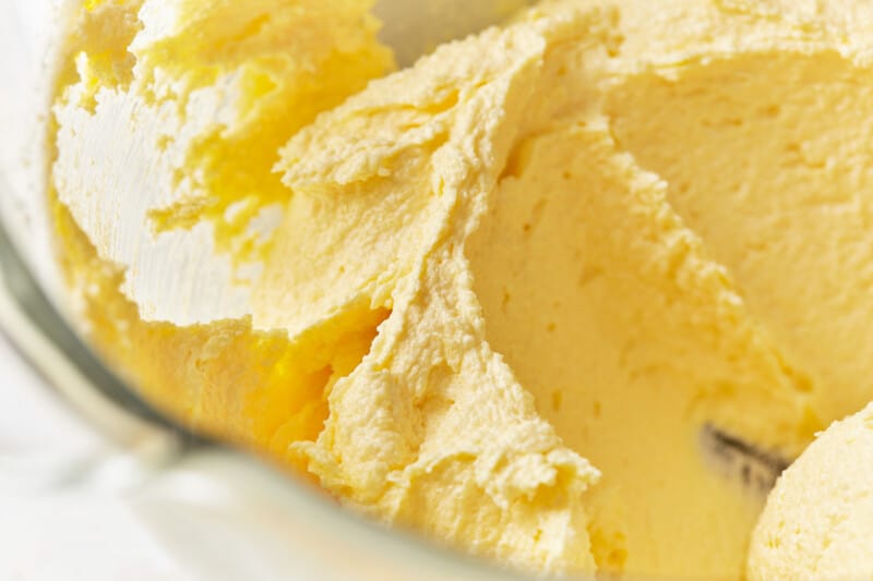 egg yolks added to Italian cream cake batter in a glass mixing bowl.