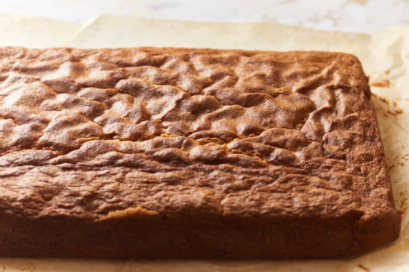 baked Italian cream cake on a cutting board.