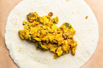 make ahead breakfast burrito filling on a flat tortilla.