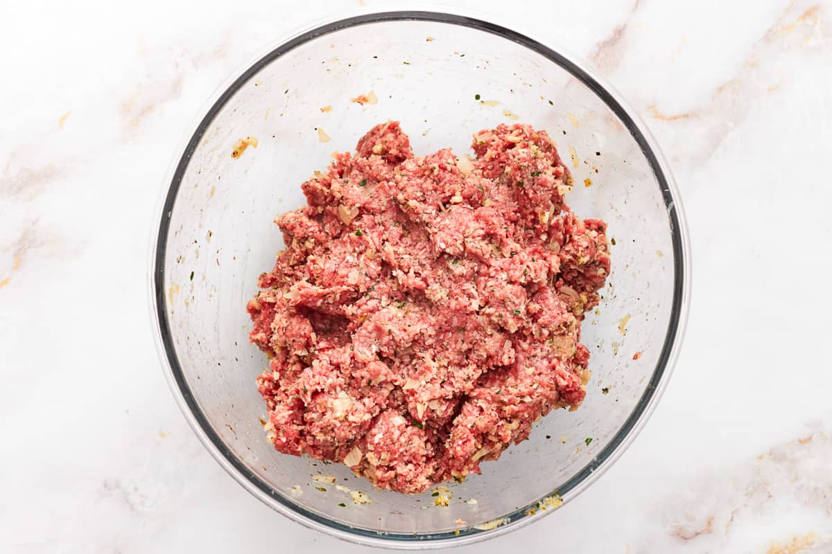 Meat mixture for mozzarella stuffed meatloaf in a glass bowl. - 9