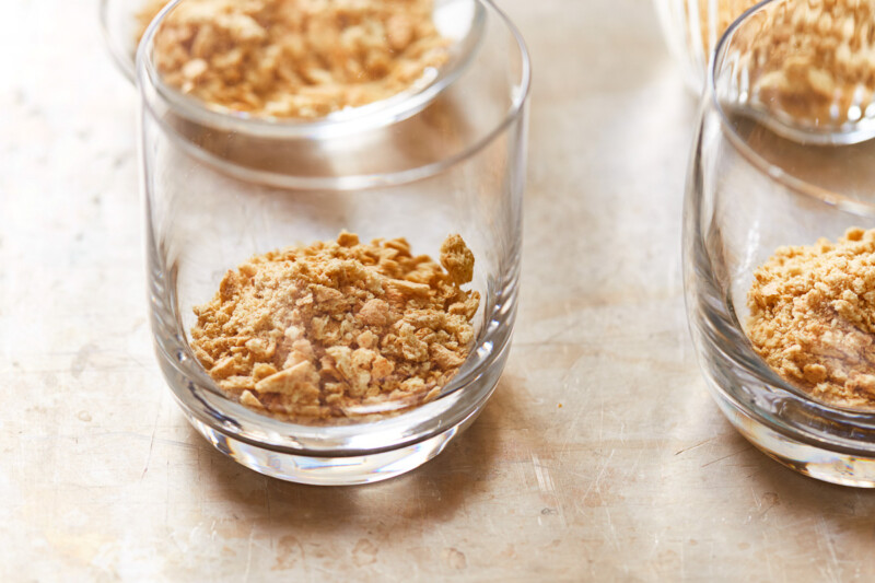 graham cracker crumbs in the bottom of short glass cups.