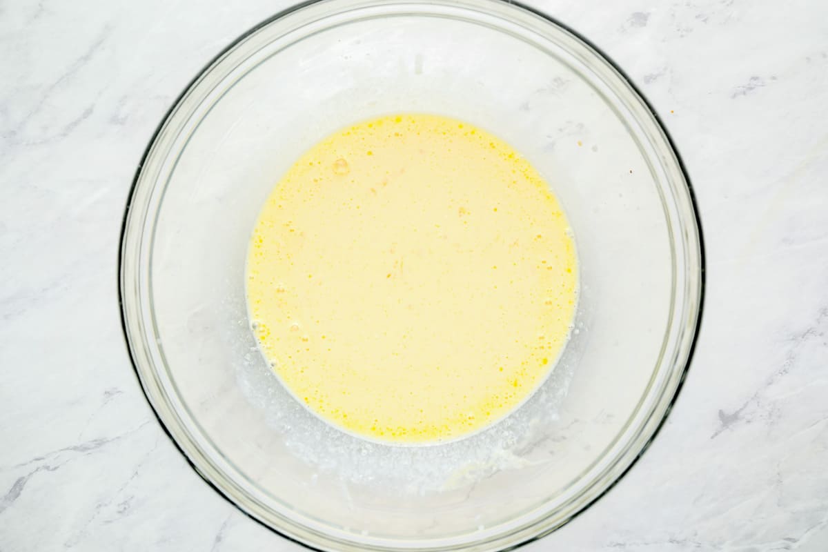 wet ingredients for pancake batter in a glass bowl.