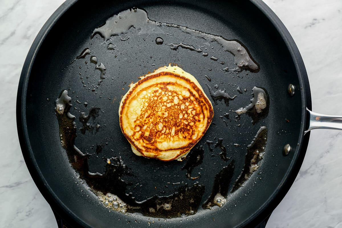 a pancake in a buttered cast iron pan.