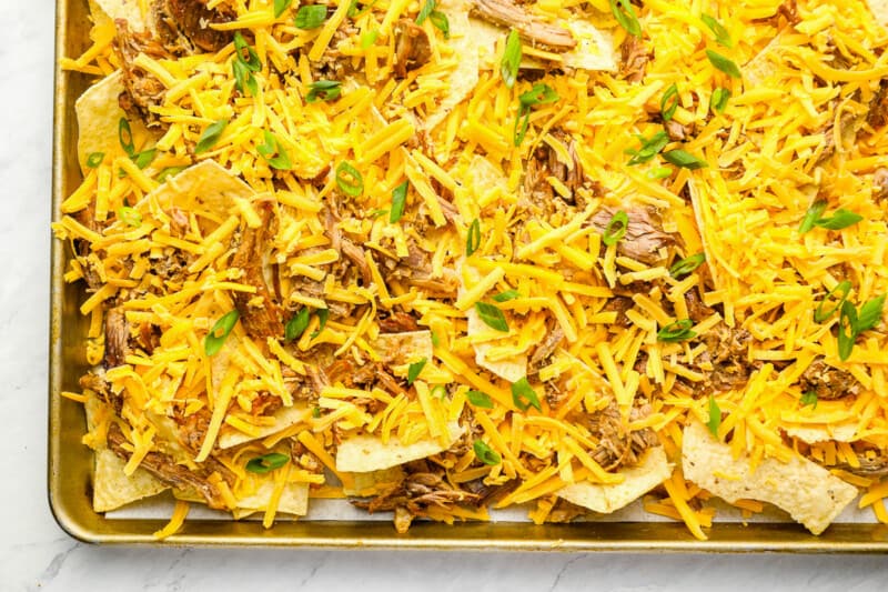 pulled pork nachos on a baking sheet.