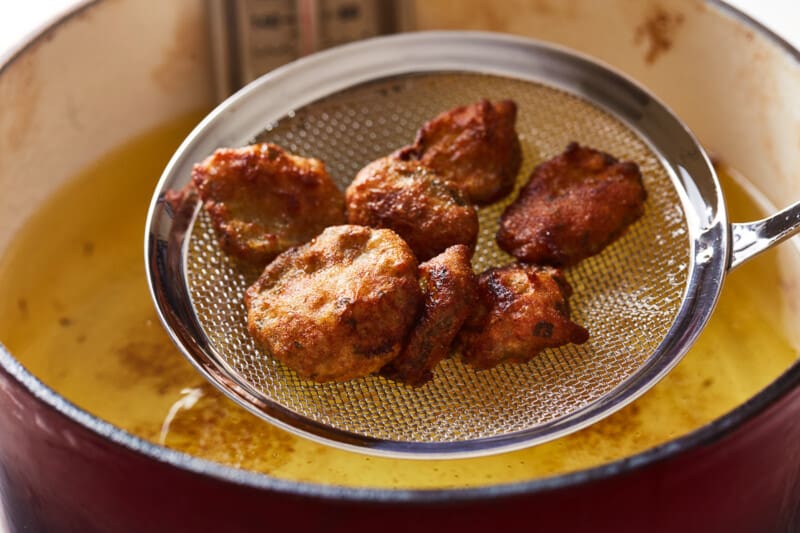 ranch fried pickles in a mesh strainer.