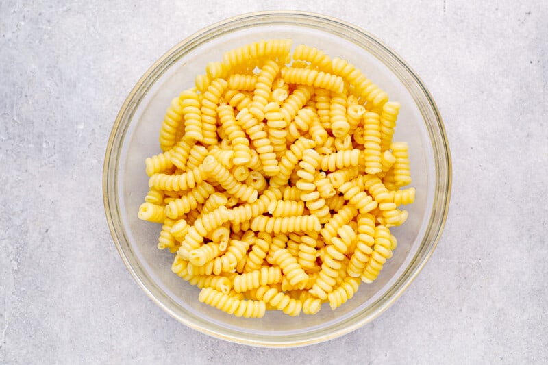 cooked drained pasta in a glass bowl.