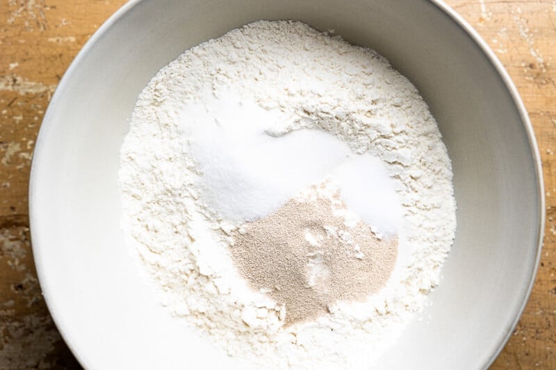 dry ingredients for no knead focaccia in a white bowl.