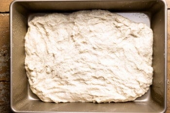 no knead focaccia dough poured into a rectangular baking pan.