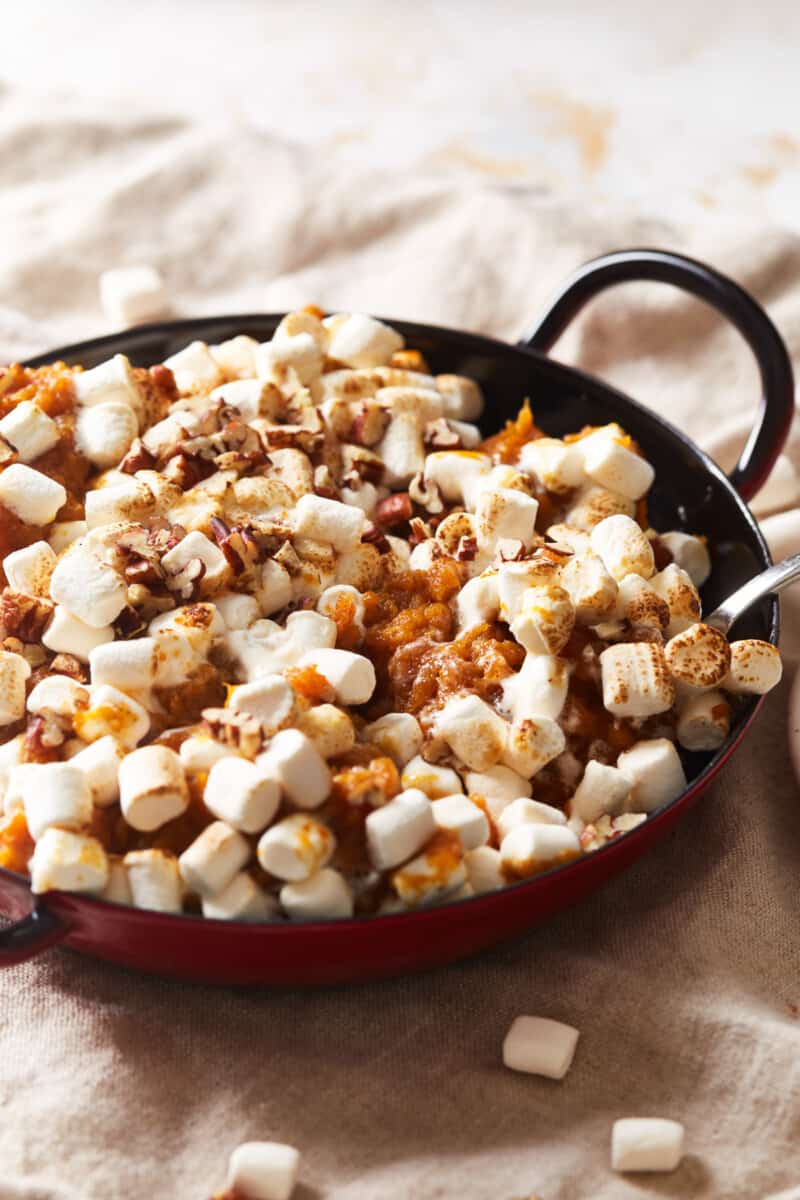 three-quarters view of instant pot sweet potato casserole in a black pan.