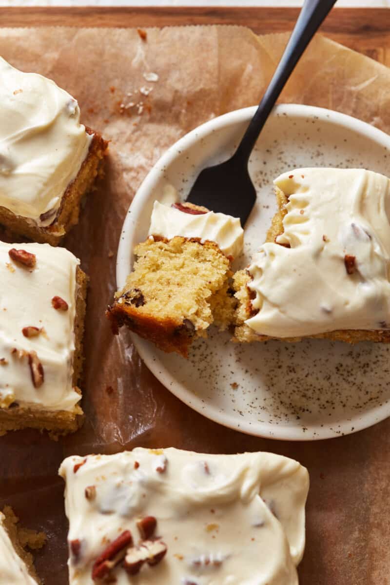 close up overhead view of a slice of Italian cream cake on a white plate with a fork.