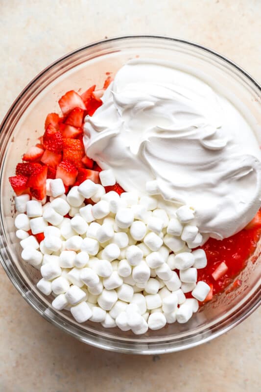 ingredients for jello salad in a glass bowl.