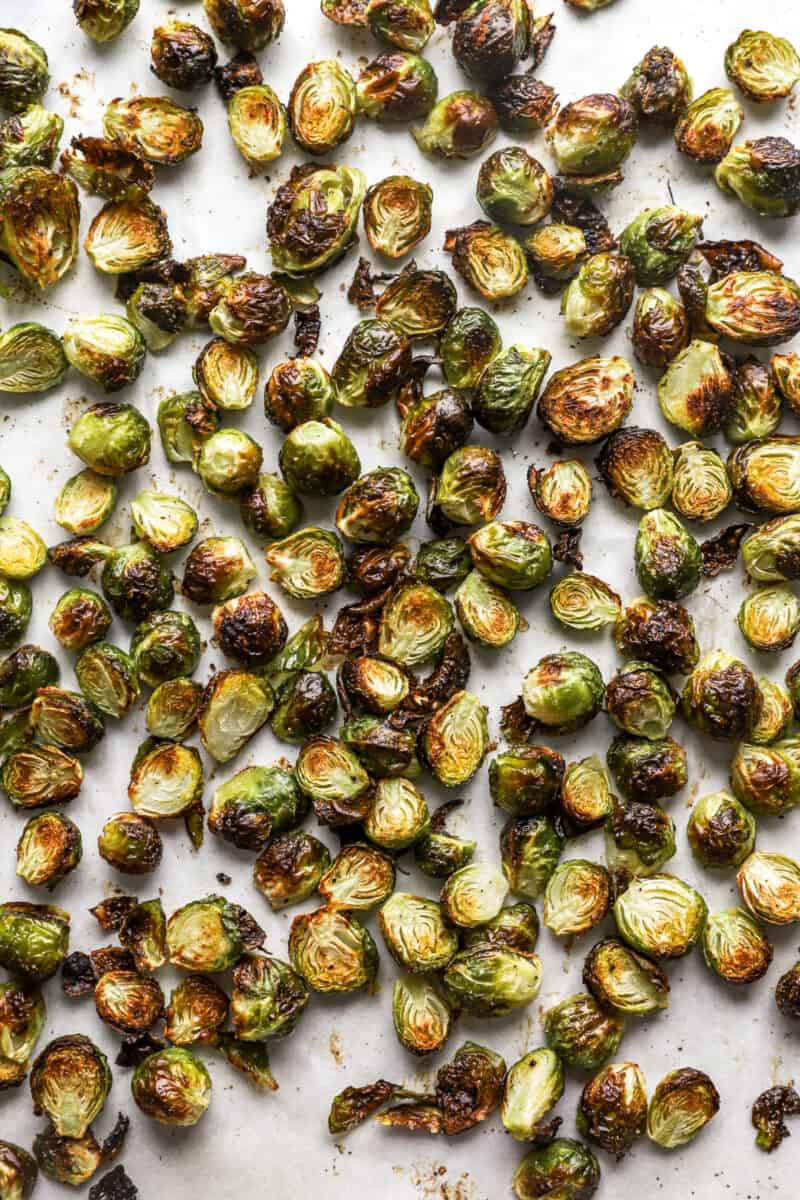 overhead view of roasted brussels sprouts on a baking sheet.