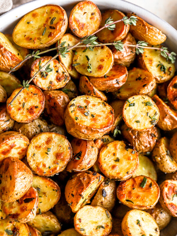 overhead view of roasted potatoes in a white bowl.