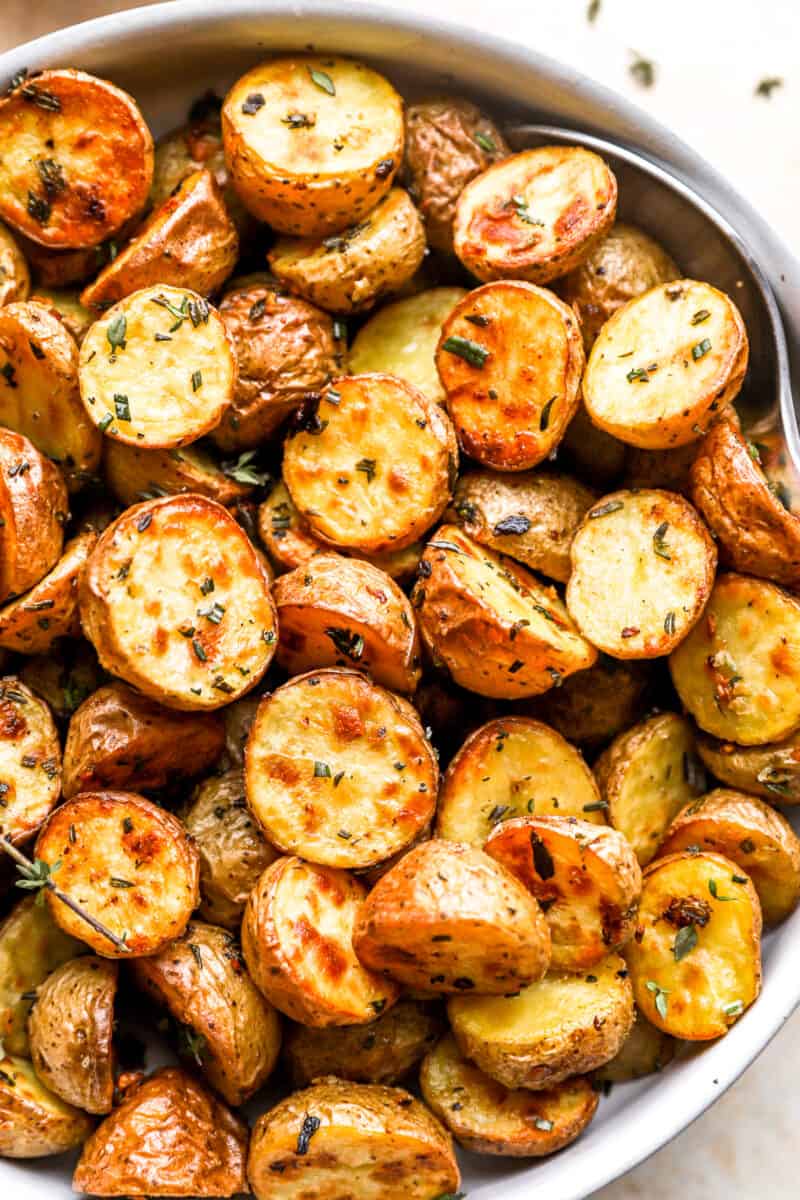 partial overhead view of roasted potatoes in a white bowl.