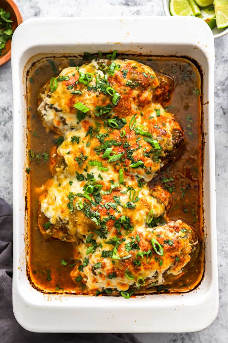 overhead view of 4 salsa verde chicken breasts in a rectangular baking dish.