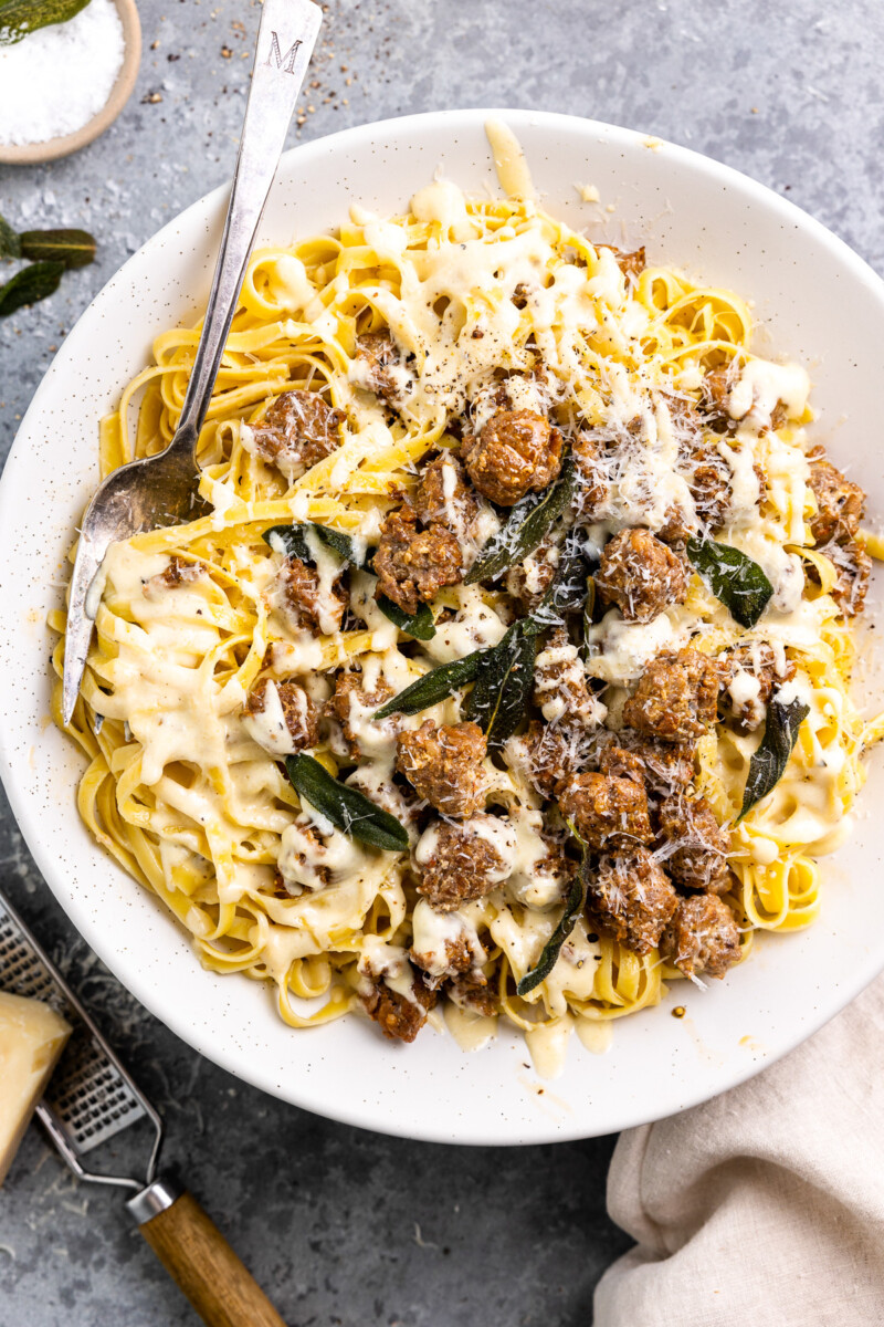 overhead view of fettuccini alfredo on a white plate with a fork.