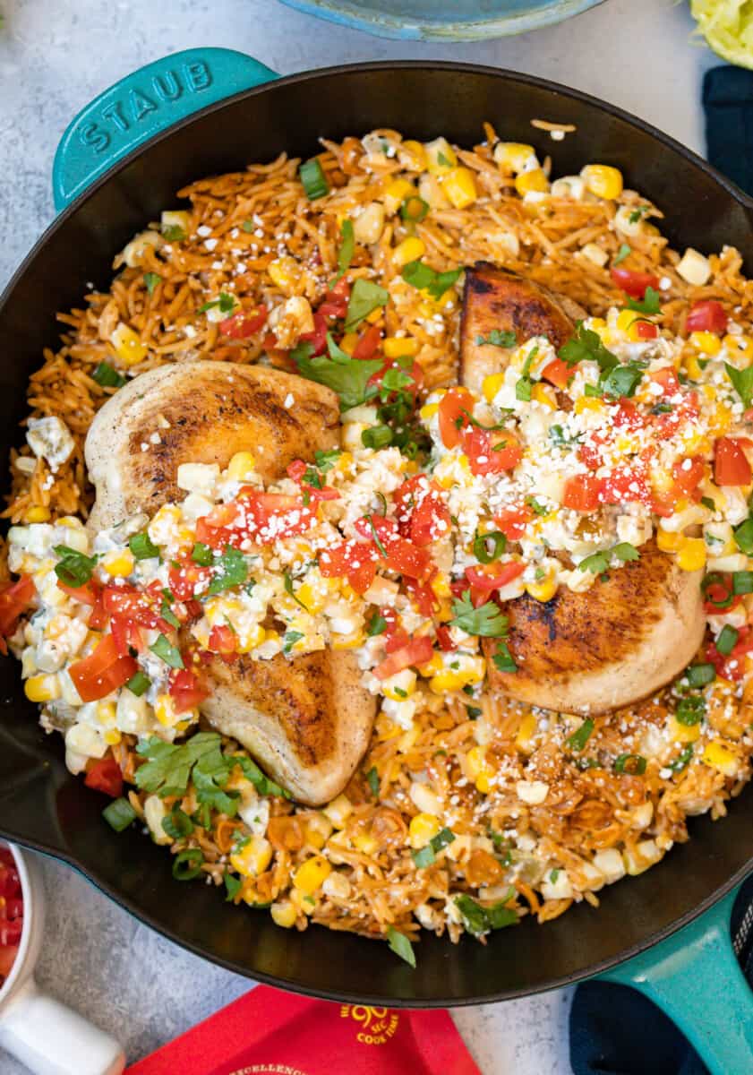 close-up overhead view of Mexican street corn chicken in a cast iron skillet.