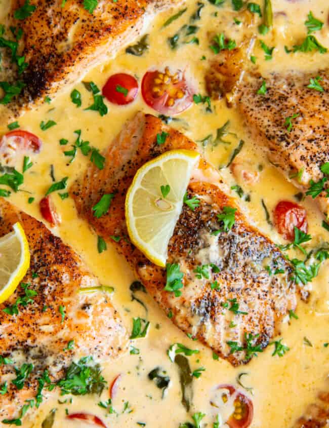 close up view of tuscan salmon in a cast iron pan.