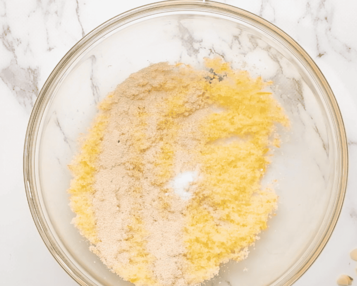 Adding dry ingredients to sugar and orange zest.