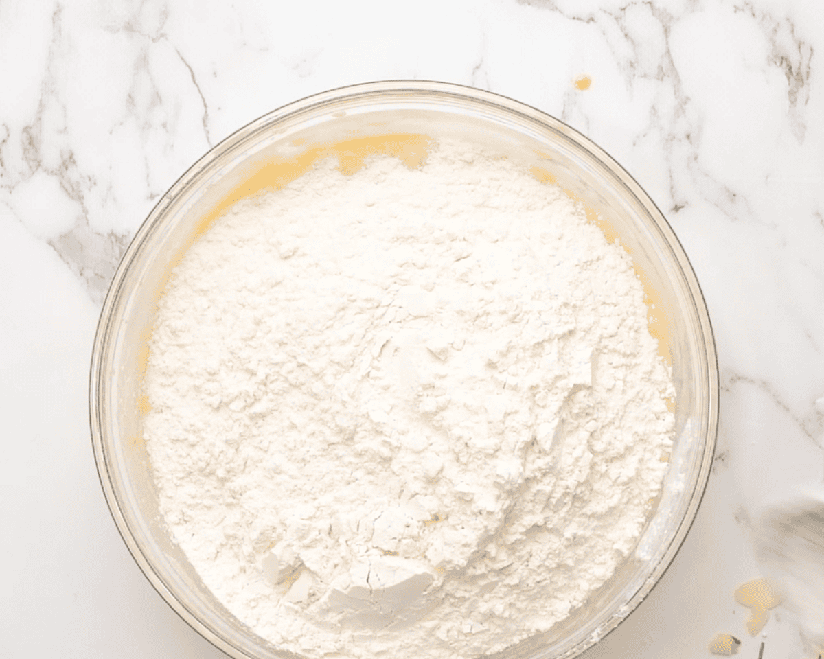 Adding flour to the dough.