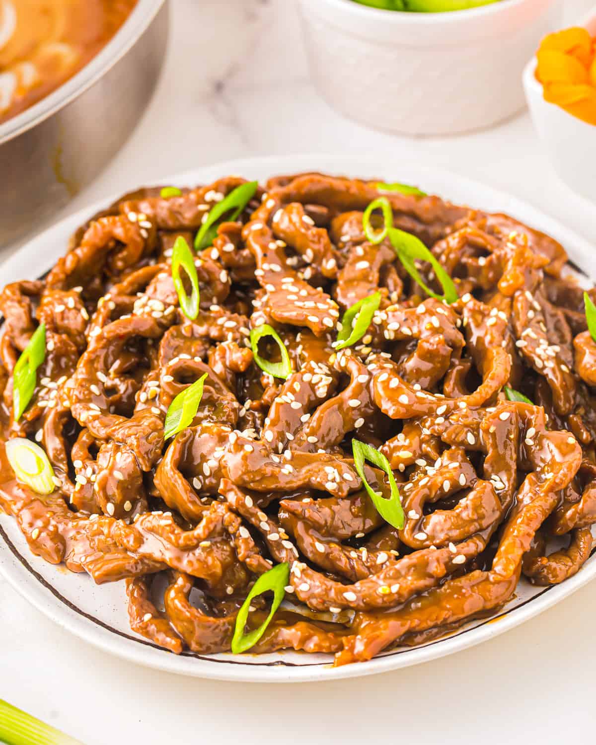 a plate of korean BBQ beef with sesame seeds.