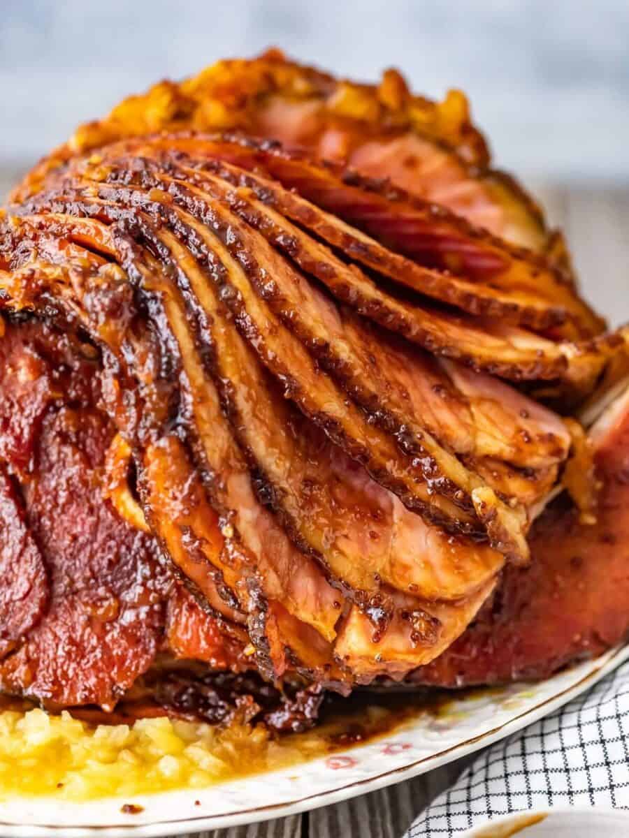 close up on a spiral ham coated in brown sugar glaze.