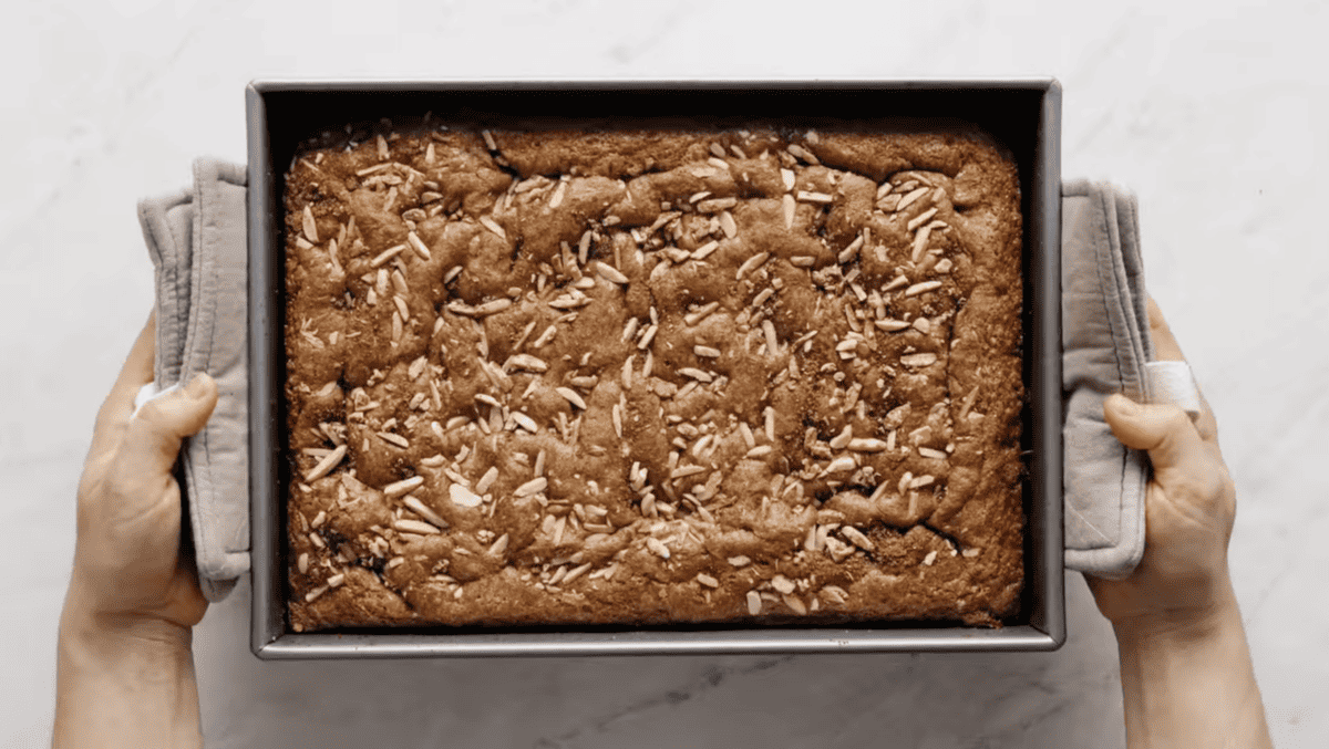 baked coffee cake in a baking pan with almonds.