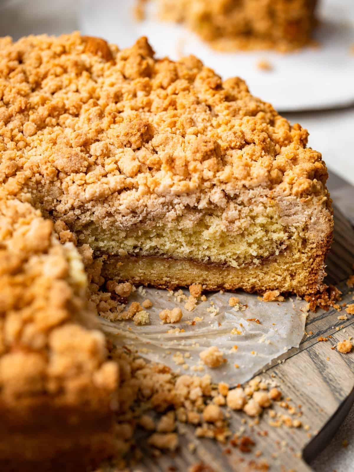 three-quarters view of a cut cake mix coffee cake on a cake plate with a slice missing.