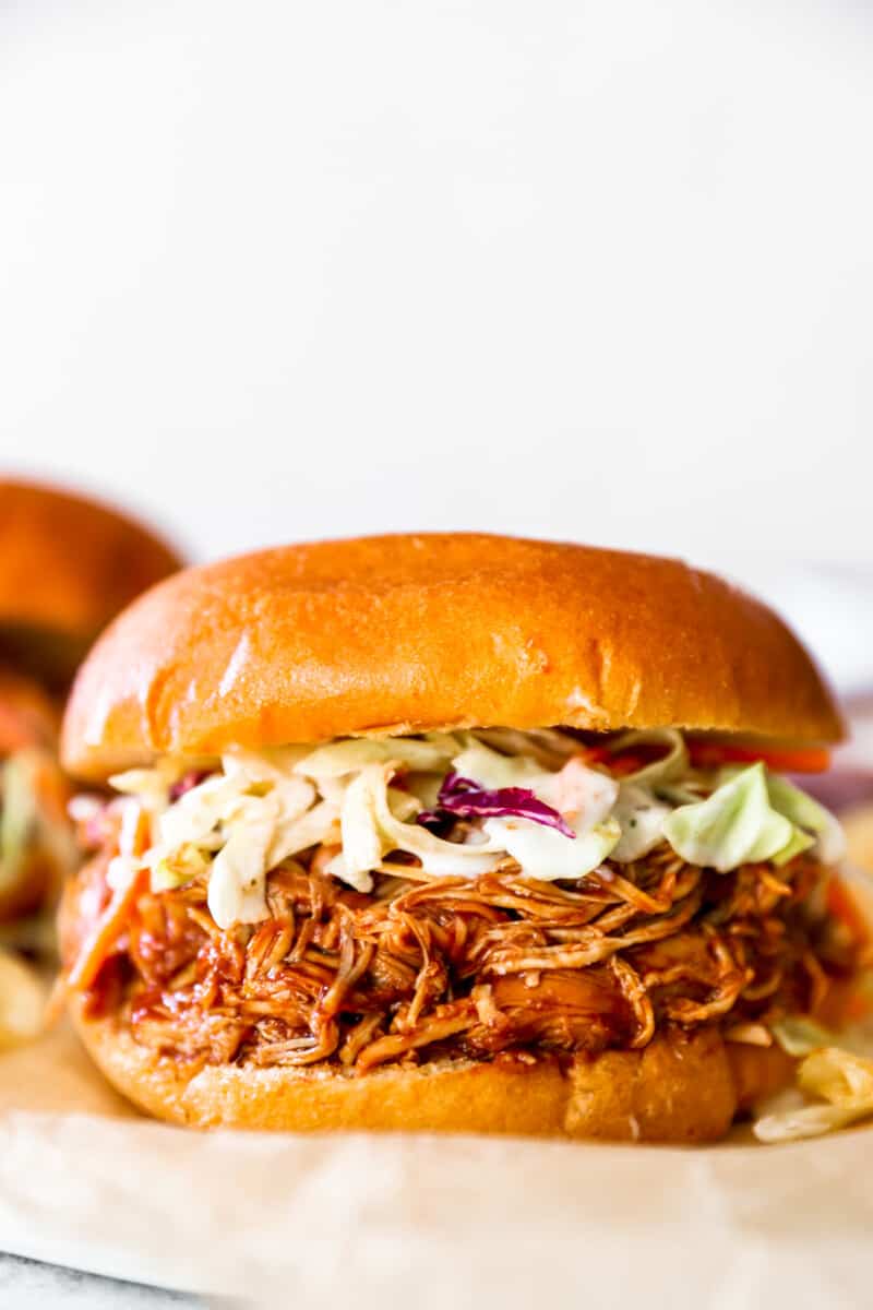 crockpot pulled bbq chicken on a sandwich with coleslaw 