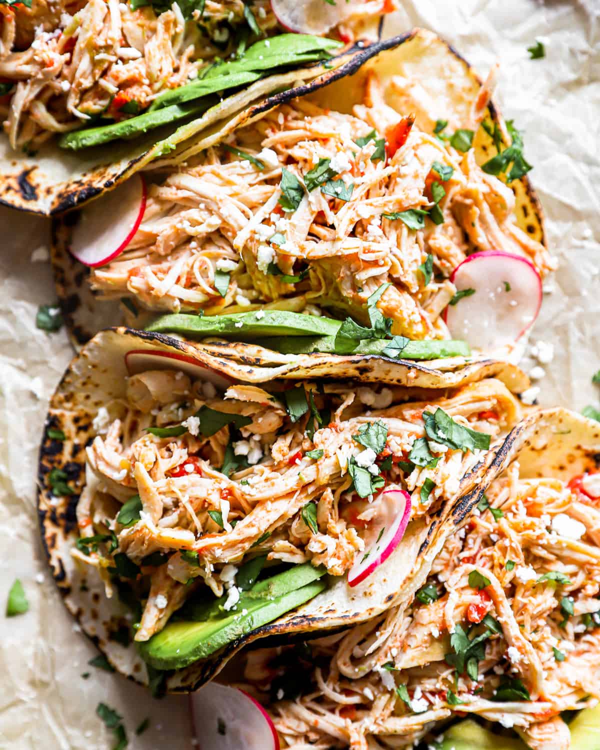 close up overhead view of 4 slow cooker chicken tacos