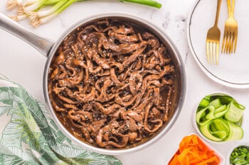 korean beef stir fry in a pan with vegetables.