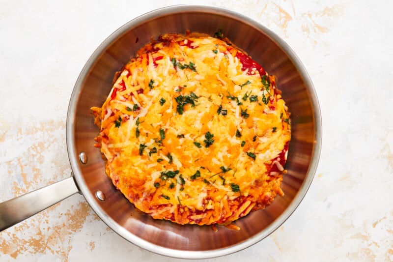 overhead view of a baked chicken enchilada skillet in a skillet.