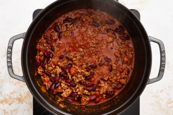 chili in a pot on top of a stove.