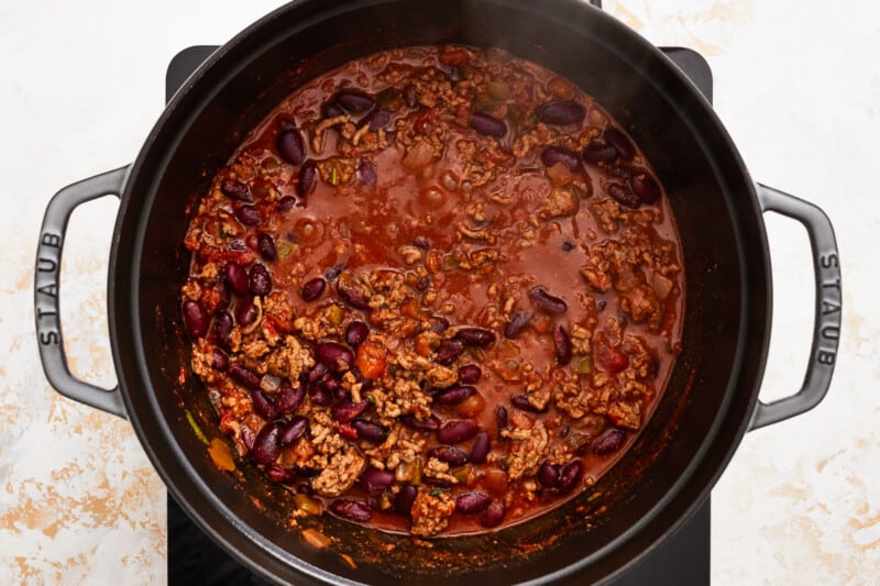 chili in a pot on top of a stove.